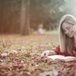 Smartphone set aside while a person relaxes outdoors with a book