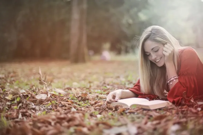 Smartphone set aside while a person relaxes outdoors with a book